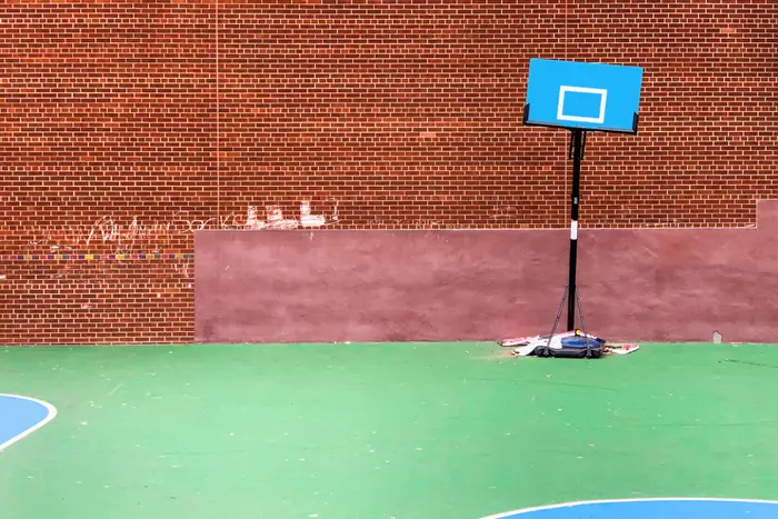 A photo of a basketball hoop taped to the ground